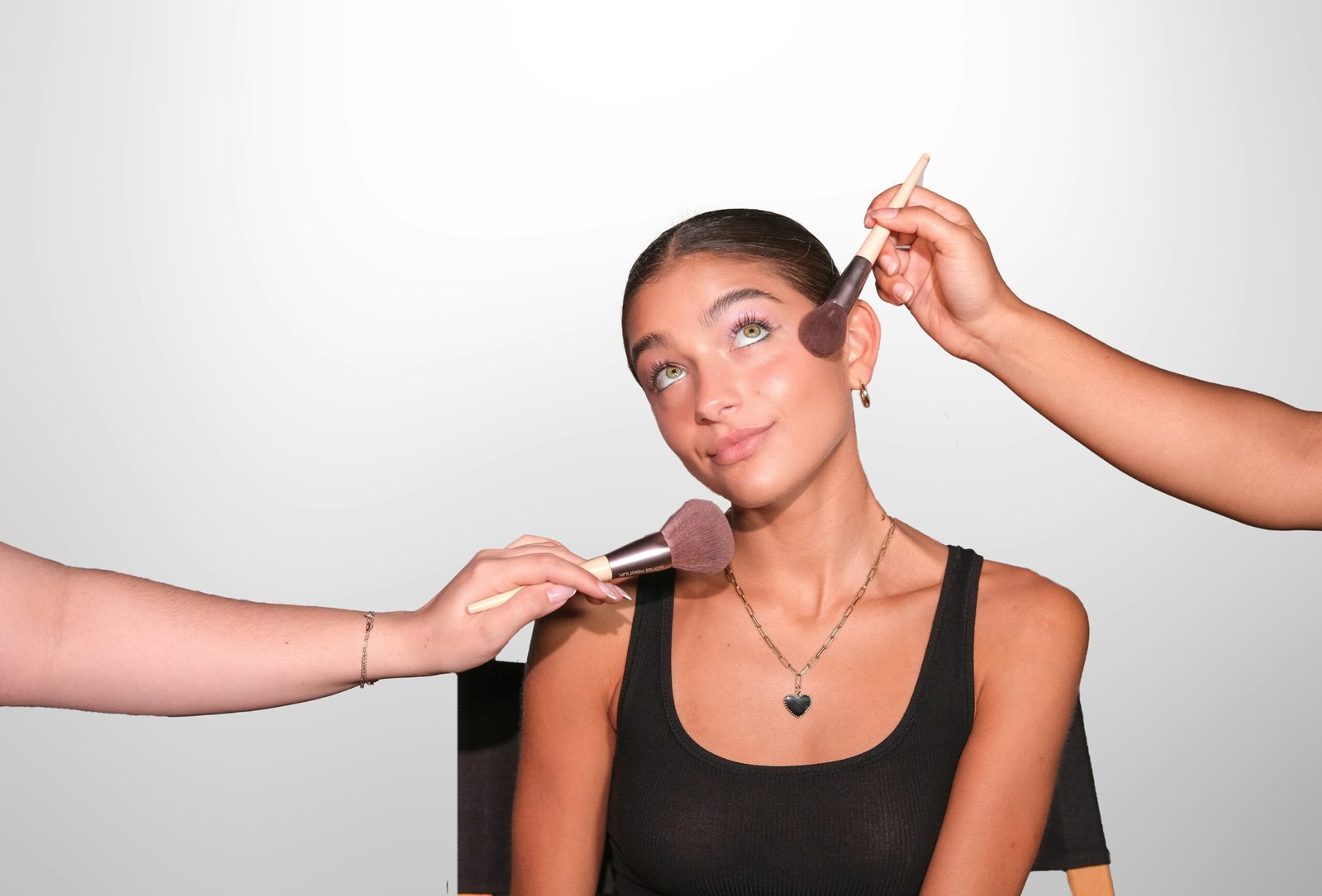 a woman is getting her make up done